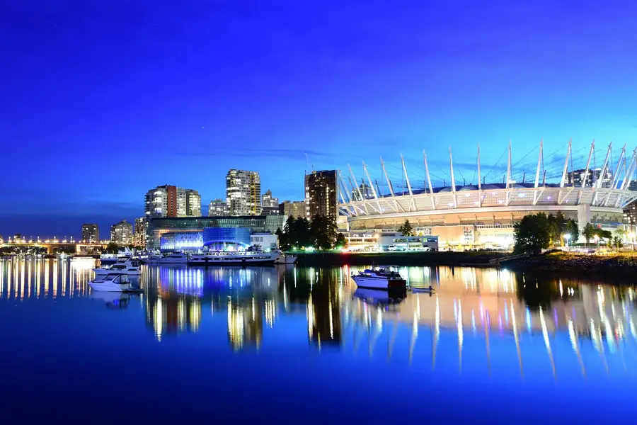 BC Place stadium and the False Creek skyline reflected in calm water at dusk, Vancouver